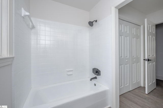 full bathroom with washtub / shower combination and wood finished floors