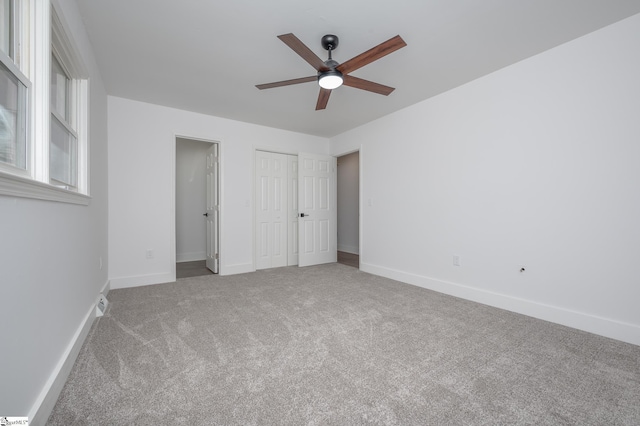 unfurnished bedroom featuring a ceiling fan, a closet, baseboards, and carpet flooring