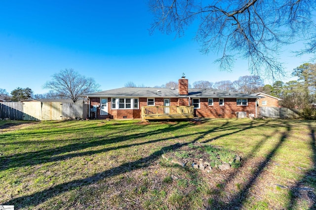 rear view of property featuring crawl space, brick siding, fence, and a chimney