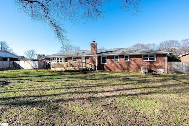 back of property with a chimney, crawl space, fence, a deck, and a yard