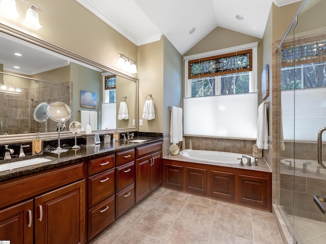 bathroom with double vanity, a stall shower, and a sink