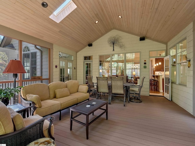 sunroom / solarium with vaulted ceiling with skylight and wooden ceiling