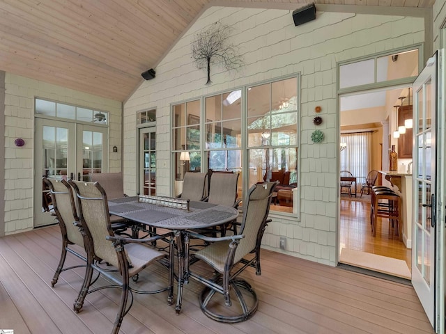 sunroom featuring wooden ceiling, vaulted ceiling, and french doors