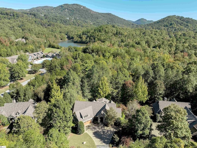 birds eye view of property with a wooded view and a water and mountain view