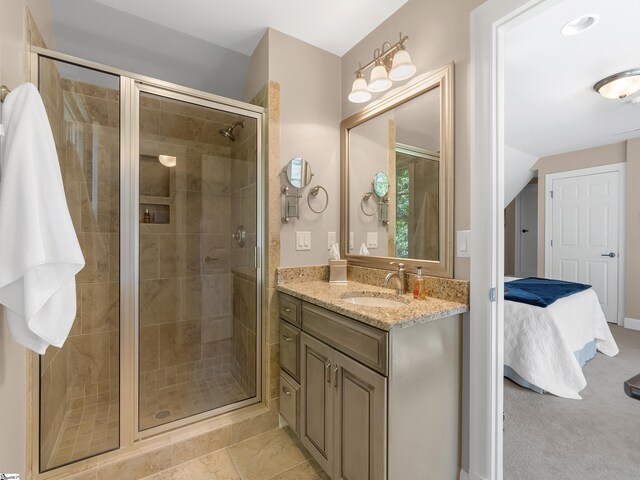 ensuite bathroom with lofted ceiling, a stall shower, connected bathroom, and vanity