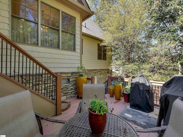 wooden deck featuring outdoor dining area and grilling area