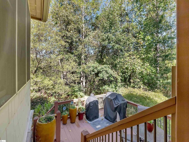 wooden terrace featuring a grill