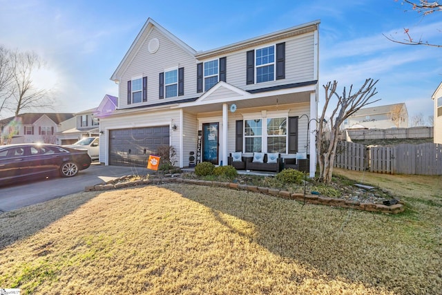 traditional-style home featuring a porch, concrete driveway, an attached garage, a front yard, and fence