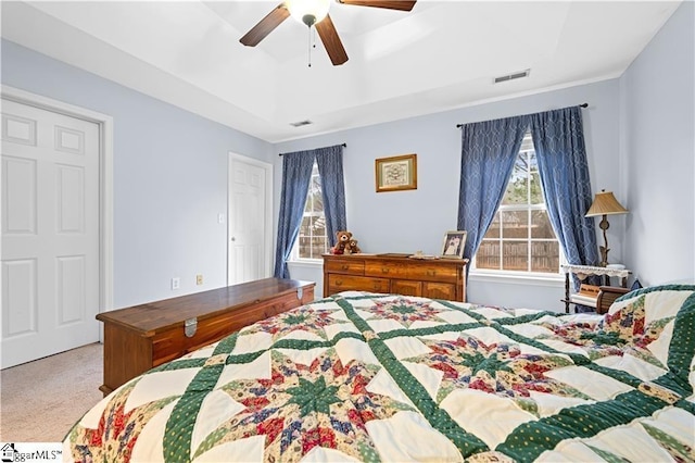 bedroom with carpet, visible vents, and ceiling fan