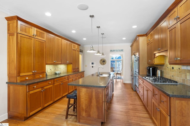 204 Waterford Ln, Greer, SC 29650 - kitchen featuring an island with sink, brown cabinetry, and a sink