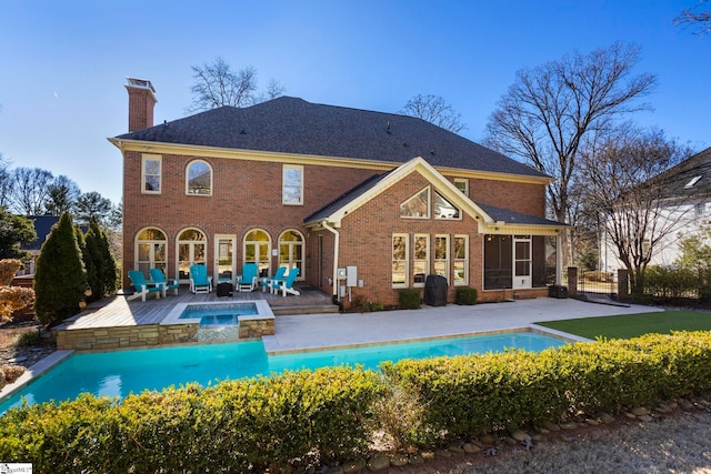 204 Waterford Ln, Greer, SC 29650 - back of property featuring a patio, an outdoor pool, a chimney, and an in ground hot tub