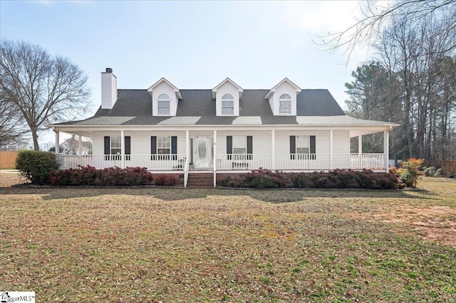 farmhouse with covered porch, a chimney, and a front lawn