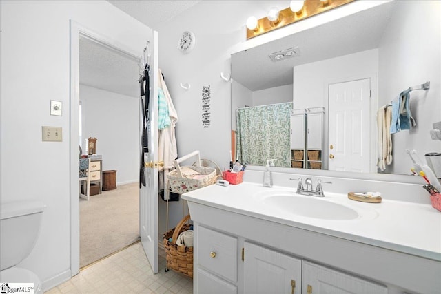 full bath with a textured ceiling, curtained shower, toilet, vanity, and tile patterned floors