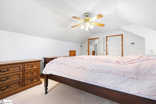 bedroom with vaulted ceiling, ceiling fan, a textured ceiling, and carpet flooring