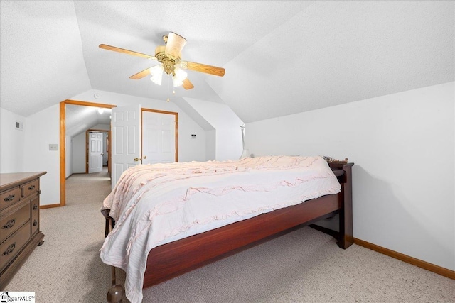 bedroom featuring lofted ceiling, ceiling fan, a textured ceiling, and baseboards