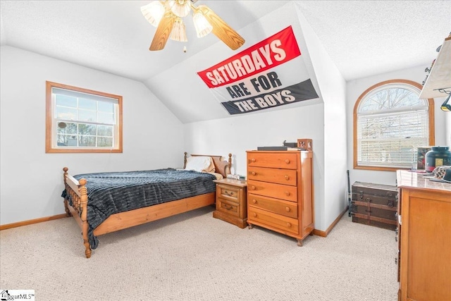 bedroom with lofted ceiling, light carpet, a textured ceiling, and baseboards