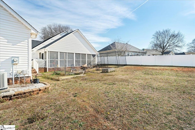 view of yard with fence and a sunroom