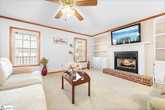 living area featuring baseboards, ornamental molding, carpet floors, a brick fireplace, and built in shelves