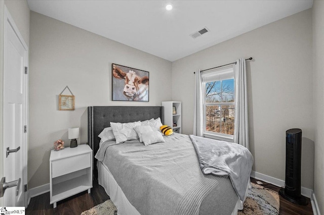 bedroom featuring dark wood-style flooring, visible vents, and baseboards