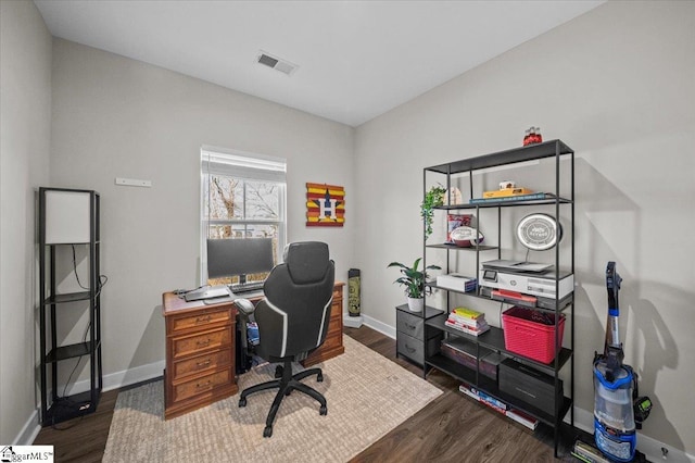 home office featuring visible vents, baseboards, and wood finished floors