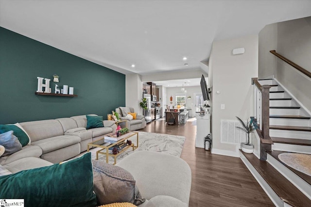 living area featuring recessed lighting, visible vents, stairway, wood finished floors, and baseboards