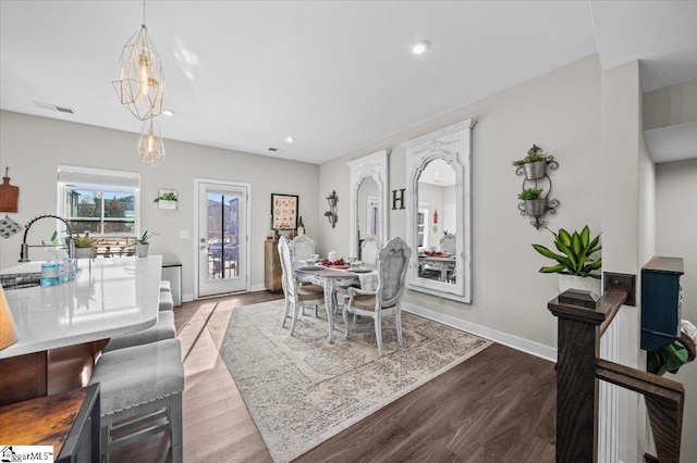 dining room with visible vents, baseboards, wood finished floors, and recessed lighting