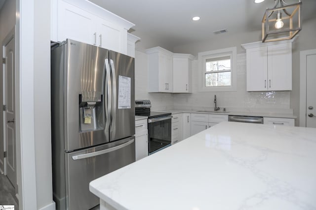 kitchen featuring stainless steel appliances, visible vents, backsplash, white cabinets, and a sink