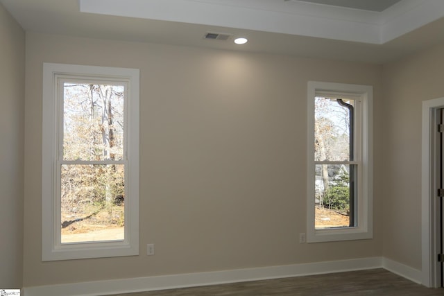 empty room featuring recessed lighting, dark wood finished floors, visible vents, and baseboards