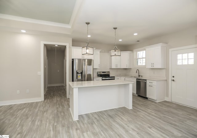 kitchen with backsplash, a kitchen island, stainless steel appliances, and a sink