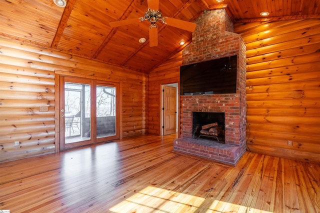 unfurnished living room featuring rustic walls, wooden ceiling, a brick fireplace, and hardwood / wood-style flooring