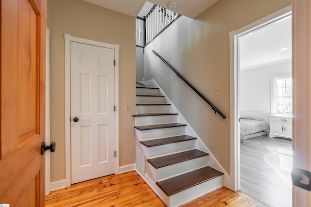 stairs featuring baseboards and wood finished floors