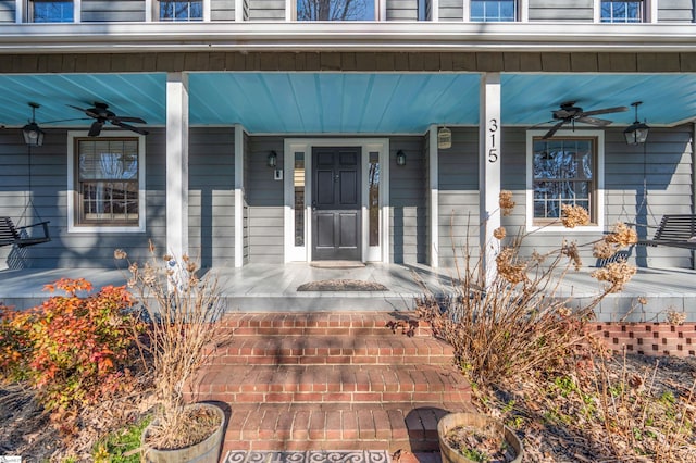 entrance to property with a porch and ceiling fan