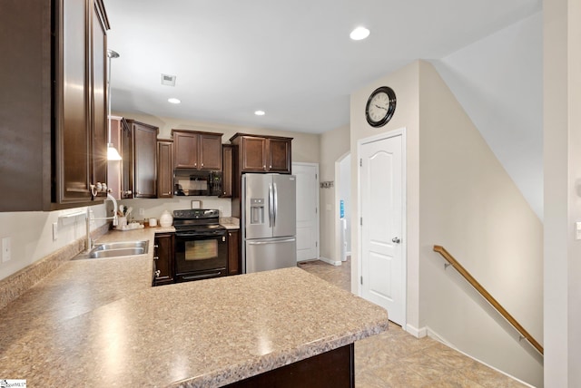 kitchen with dark brown cabinetry, light countertops, a sink, and black appliances