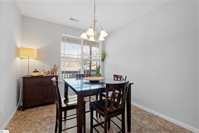 dining area featuring baseboards, visible vents, and an inviting chandelier