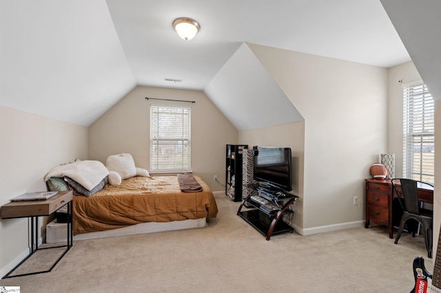 carpeted bedroom featuring lofted ceiling, baseboards, multiple windows, and visible vents