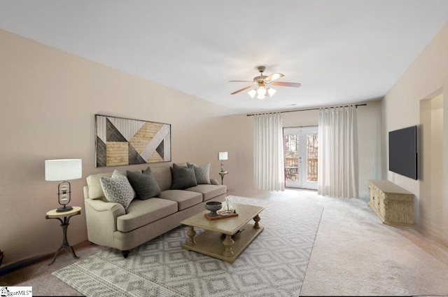 living room featuring a ceiling fan, carpet, and french doors