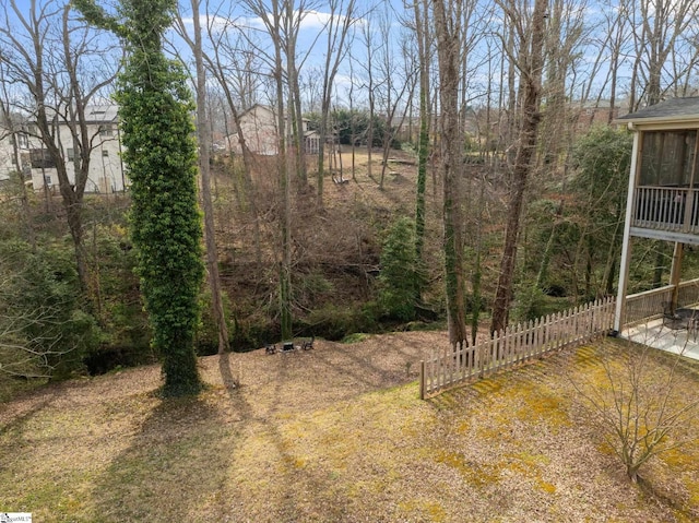 view of yard with a sunroom and fence