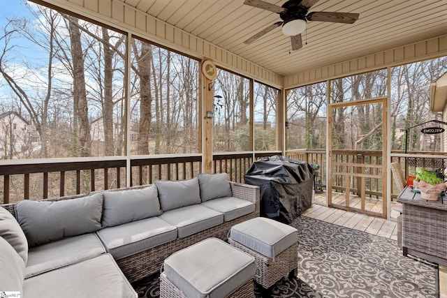 sunroom / solarium with ceiling fan, wood ceiling, and a healthy amount of sunlight