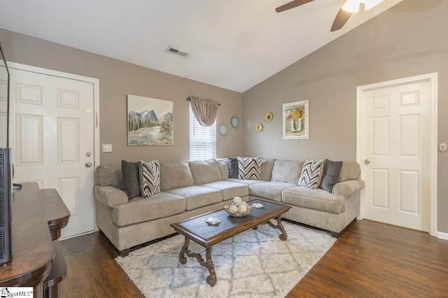 living area with dark wood-type flooring, lofted ceiling, visible vents, and ceiling fan