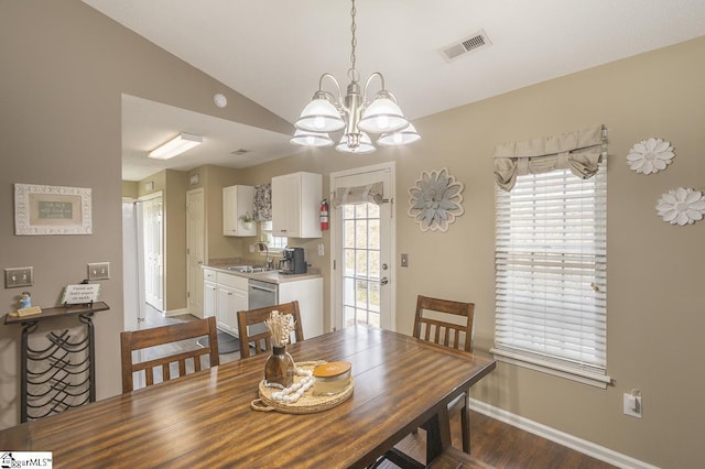 dining area featuring visible vents, vaulted ceiling, baseboards, and an inviting chandelier