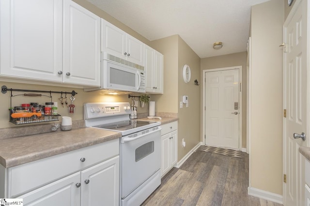 kitchen with white appliances, baseboards, white cabinets, wood finished floors, and light countertops