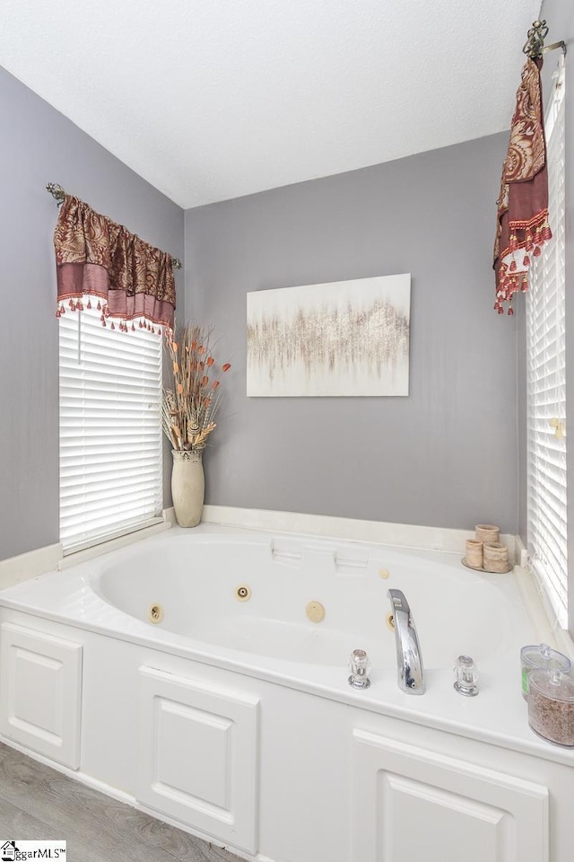 full bath featuring a whirlpool tub