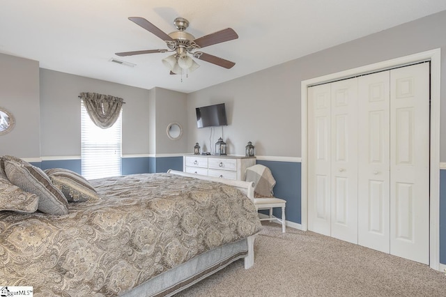 carpeted bedroom featuring a closet, visible vents, and ceiling fan