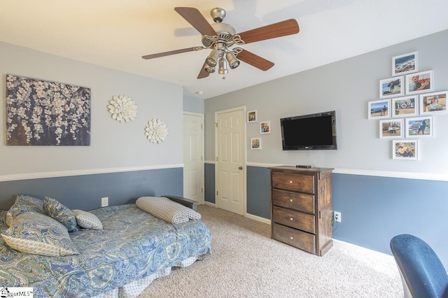 carpeted bedroom with a ceiling fan and baseboards