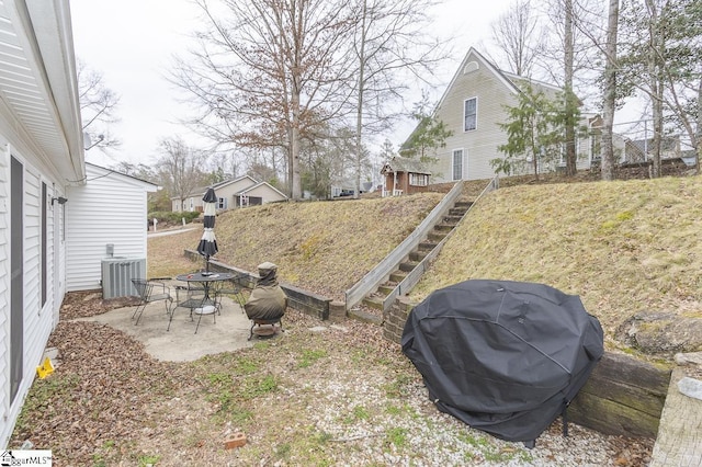 view of yard featuring a patio area and central AC