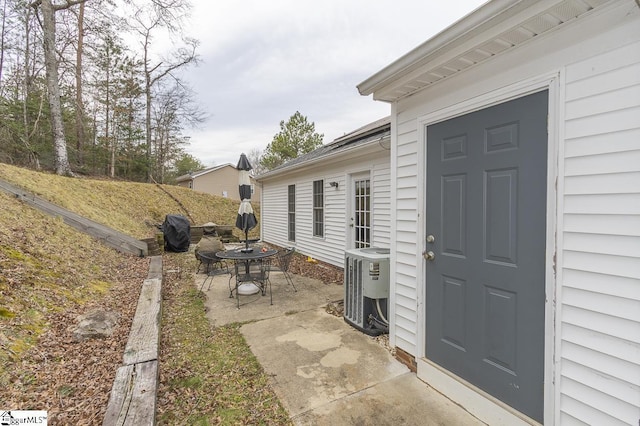 entrance to property featuring a patio area and central AC