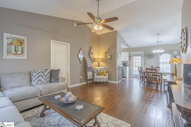 living room with baseboards, vaulted ceiling, hardwood / wood-style floors, and ceiling fan with notable chandelier