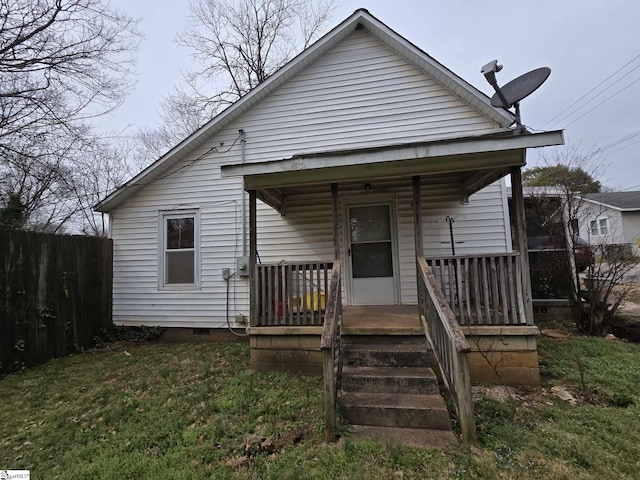 view of front of house with covered porch, fence, and crawl space