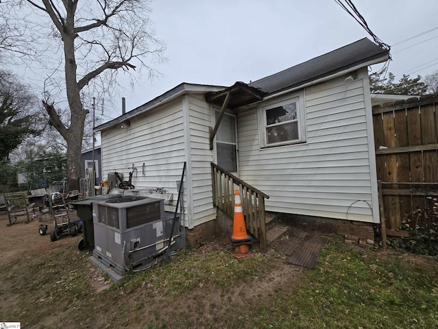 rear view of house featuring fence