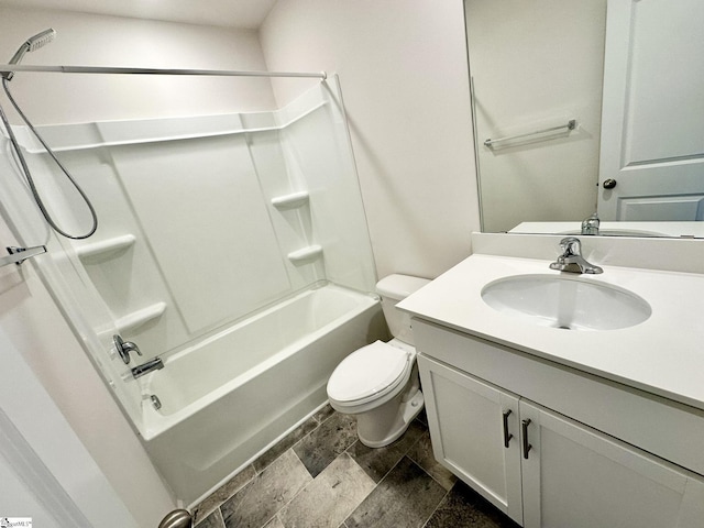 bathroom with toilet, stone finish flooring, bathtub / shower combination, and vanity